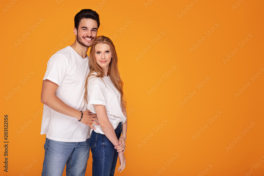 Happy young couple posing in studio. Happy young couple posing in studio.
