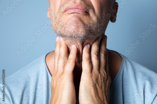 Fotografie Close-up Of A Man Touching His Sore Throat