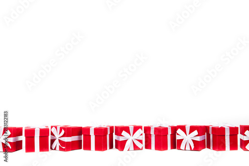Christmas red gift boxes stay in line with copy space. Isolated on white