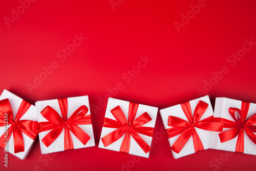 Christmas white gift presents on red background. Top view with copy space. Horizontal