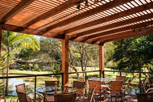 wood pergola and tables in garden farm