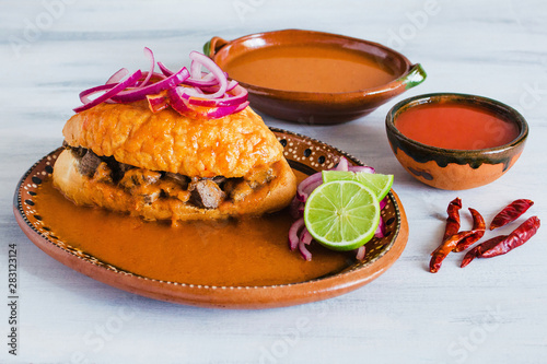 tortas ahogadas, traditional Mexican Food from Jalisco Guadalajara Mexico, spicy sandwich in a red sauce