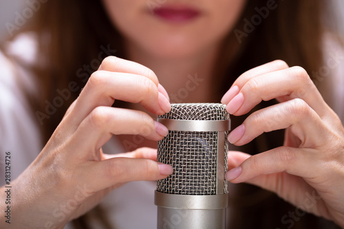 Woman scratching with nails to make ASMR sounds photo