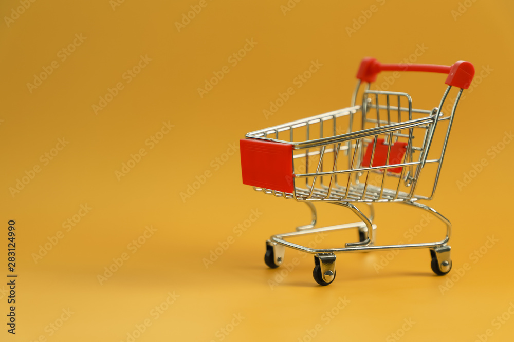 mini empty shopping cart  isolated on yellow background