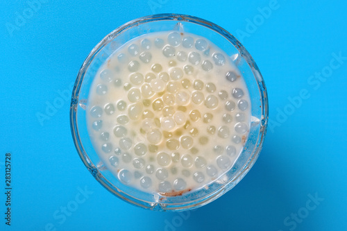 top view bowl of Chinese syrup of sago on blue background