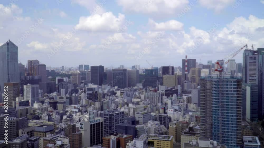 High angle daytime view of Tokyo city on a cloudy day. Zoom out. High angle daytime view of Tokyo city on a cloudy day. Zoom out.