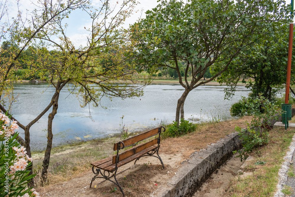 Empty wooden park bench overlooking Viroi lake. Empty wooden park bench overlooking Viroi lake.