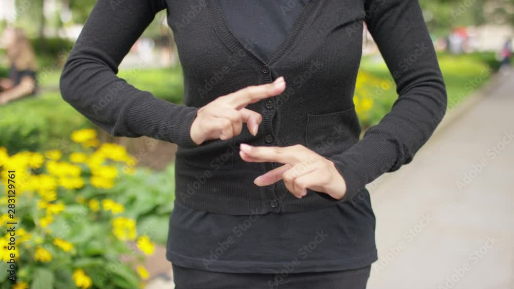 Hands of a female doing the alphabet in sign language