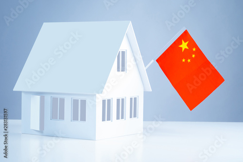 Moving to permanent residence in Beijing. Trip exchange students in Beijing. Immigration. China flag on the layout of the cottage. Buying property in China.