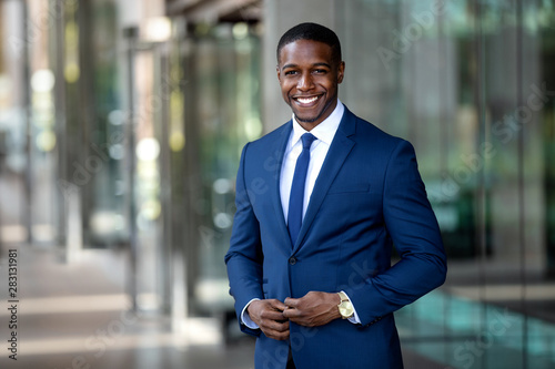 Εκτύπωση καμβά Handsome charming cheerful african american businessman in swanky modern stylish