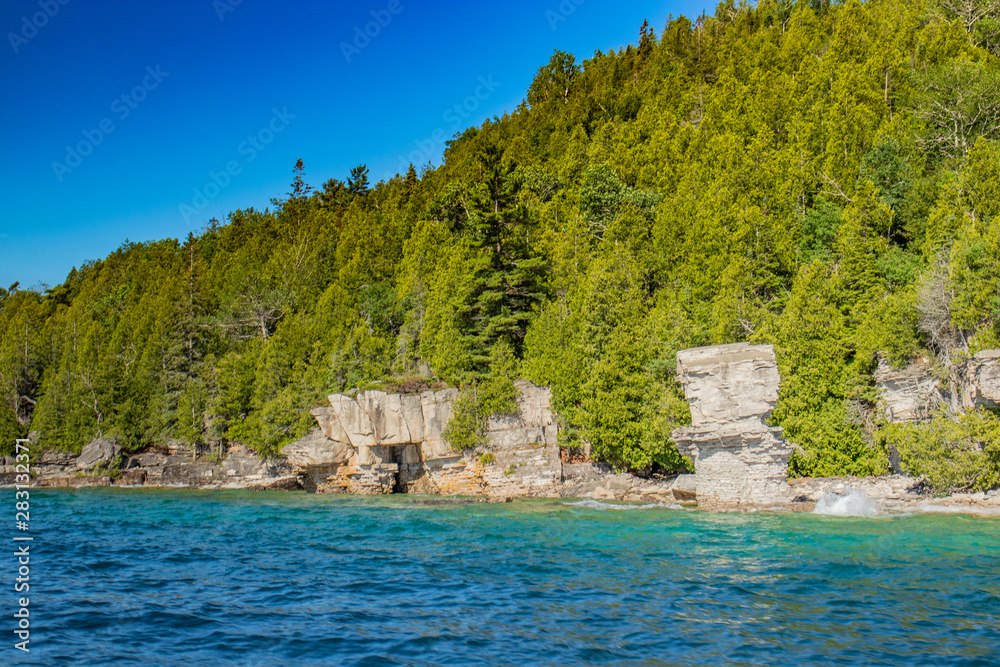 Sky, rocks, cliffs and blue lake waters of Lake Huron, ON
