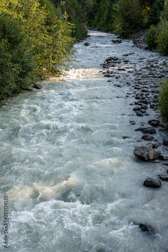 Landscape of glacier melt in Fitzsimmons Creek, mixed forest of deciduous and evergreen, Whistler BC Canada photo