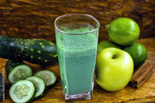 Green detox juice, kale leaves, lemon, apple, lettuce, cucumber, lime and other green vegetables. Copy space. Vegetarian juice, alkaline food concept. Healthy life. Copy space Raw, vegan, vegetarian.