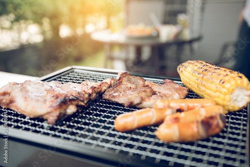 Close up grill with meat and sausage ready for socializing celebrate at outsite home. photo