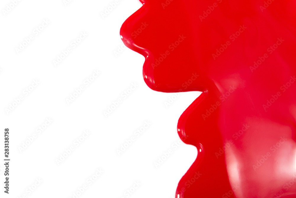 Fluid red nail polish isolated on white.