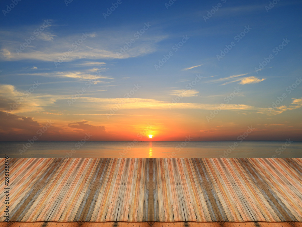 Wood table top on sunset background