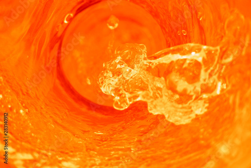 Orange fluid flowing on top