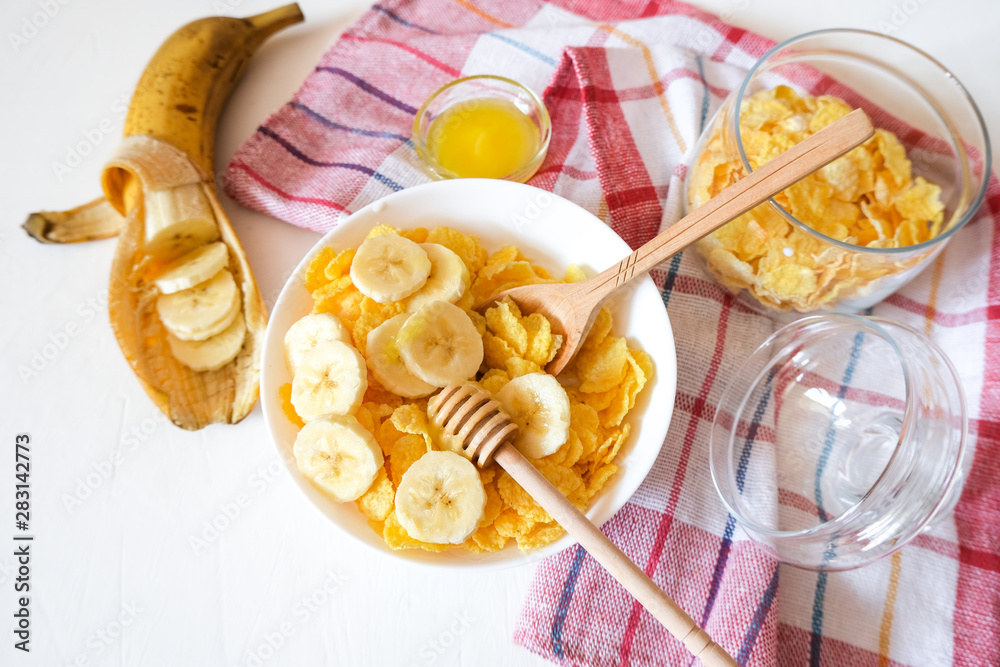 Traditional breakfast cereal of cornflakes and milk with a banana. Healthy lifestyle food. Traditional breakfast cereal of cornflakes and milk with a banana. Healthy lifestyle food.