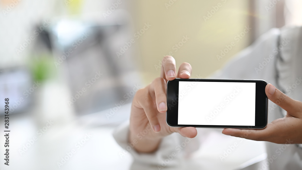 Female holding mockup mobile phone with empty screen, Clipping path and Montage display.