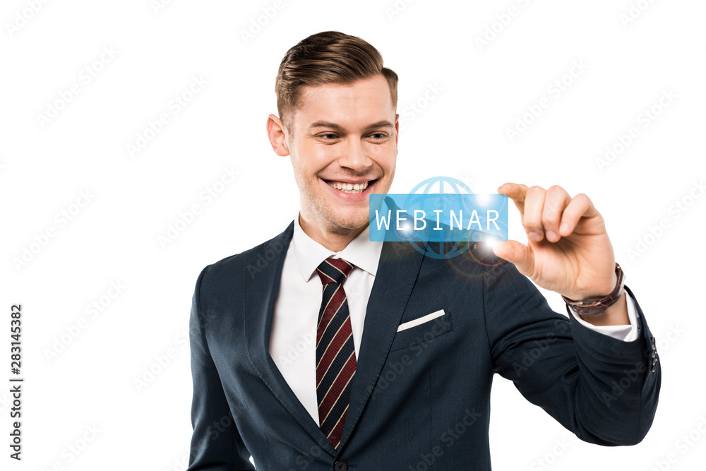 happy businessman gesturing and smiling while looking at webinar lettering on while happy businessman gesturing and smiling while looking at webinar lettering on while