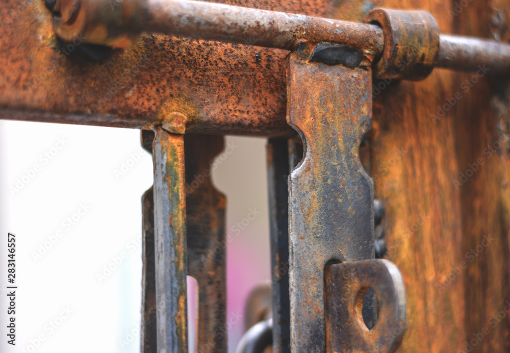 A rusted Gate with a handle lock A rusted Gate with a handle lock