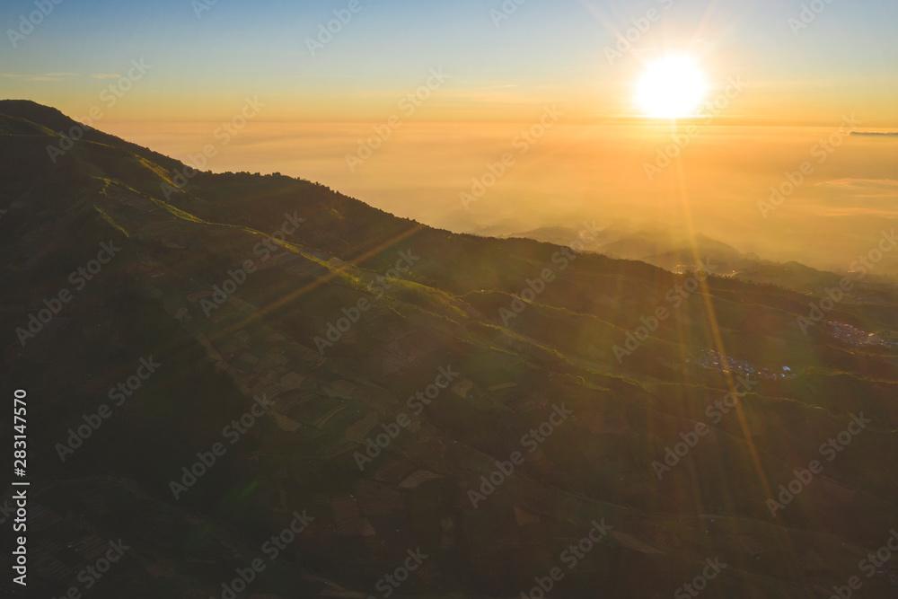 Dieng plateau with farmland at sunrise time