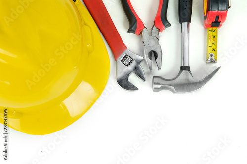 Handy tools with yellow helmet on the table
