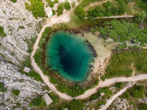 Croatia, august 2019: The spring of the Cetina River (izvor Cetine) in the foothills of the Dinara Mountain is named Blue Eye (Modro oko). A more than 150 meter-deep shaft. photo