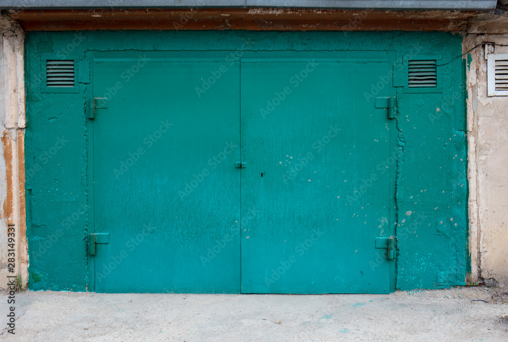 old metal door to the car garage