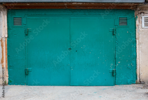 old metal door to the car garage © vadim_fl