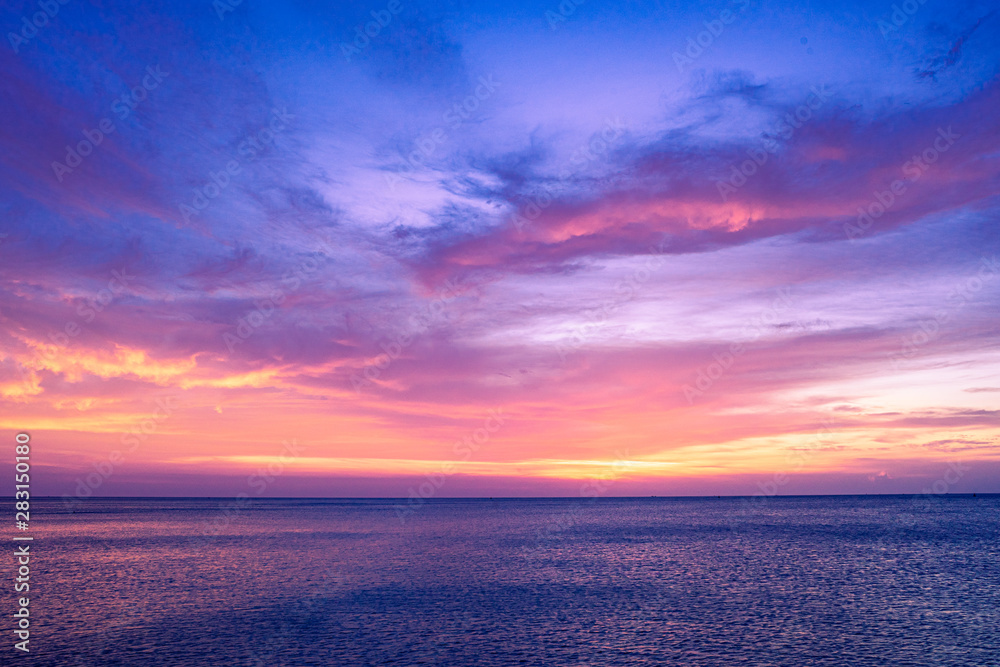 Colorful sunset sky over the ocean with dramatic cloud formation