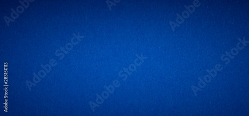 blue flat color paper sheet with light accent in the middle, vignetted background