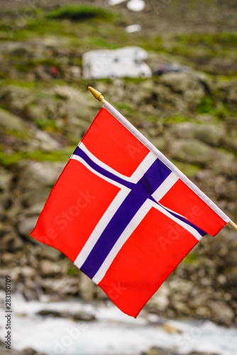 Norwegian flag and camper car in mountains photo