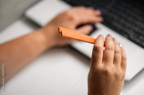 Unhealthy snack. Woman eating sugary food at workplace. Brain work improvement during hard work, sugar addiction, stressful lifestyle, weight gain, dietary and medical concept. © Vadym