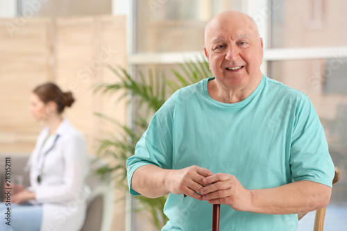 Wallpaper Mural Elderly man with cane in nursing home, space for text. Assisting senior generation Torontodigital.ca