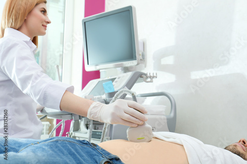 Doctor conducting ultrasound examination of internal organs in clinic