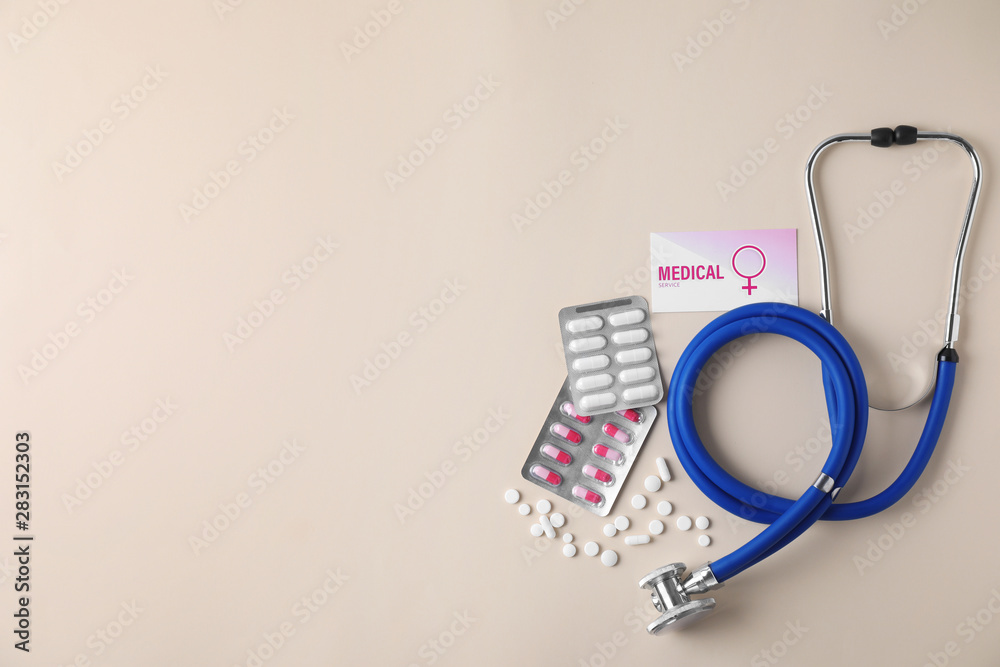 Flat lay composition with stethoscope and pills on beige background, space for text. Gynecology concept Flat lay composition with stethoscope and pills on beige background, space for text. Gynecology concept
