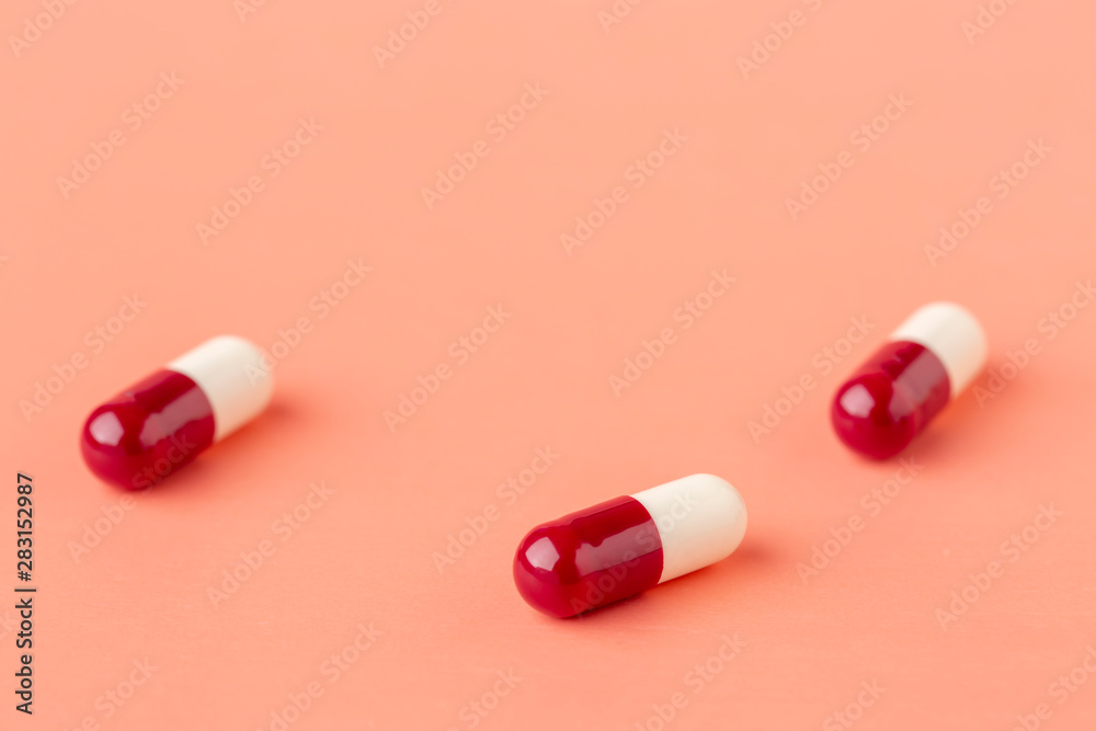 Scattering of red and white drug capsules Scattering of red and white drug capsules