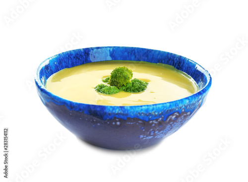 Bowl of cheese cream soup with broccoli on white background