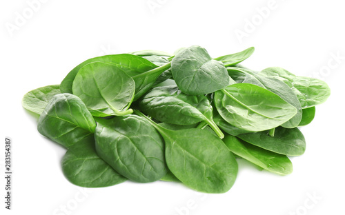 Pile of fresh green healthy baby spinach leaves on white background