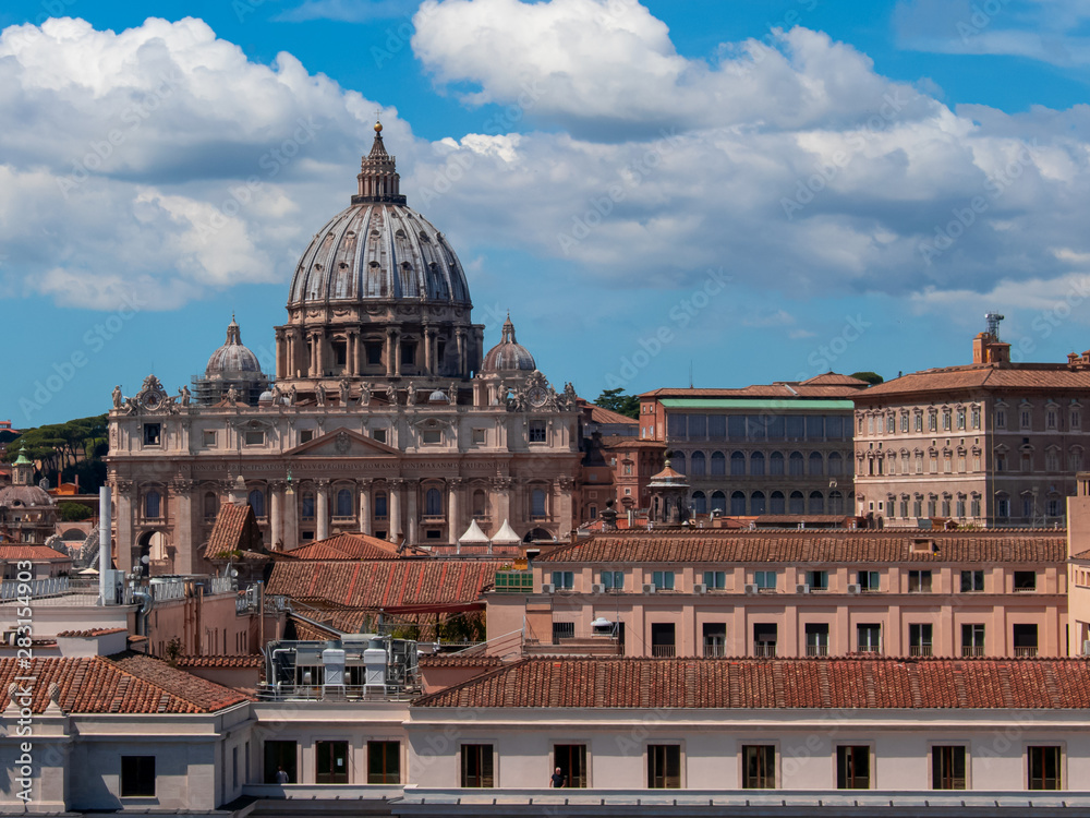 Beautiful aerial view on the St. Peter's Basilica ( Famous Roman landmark ) and ancient classical buildings of the Vatican on background of clouds. City of Rome. Italy. Europe