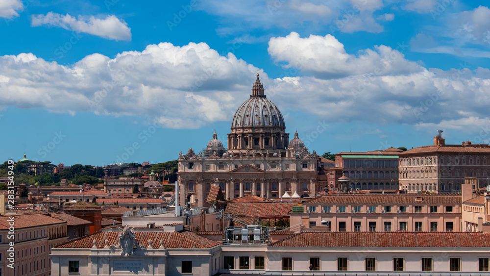 Beautiful aerial view on the St. Peter's Basilica ( Famous Roman landmark ) and ancient classical buildings of the Vatican on background of clouds. City of Rome. Italy. Europe