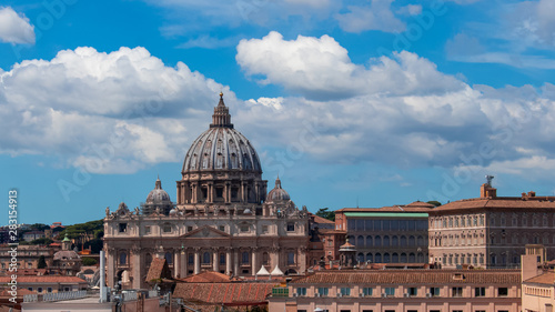 Beautiful aerial view on the St. Peter's Basilica ( Famous Roman landmark ) and ancient classical buildings of the Vatican on background of clouds. City of Rome. Italy. Europe