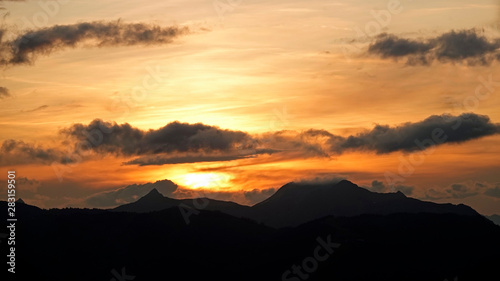 beautiful sunset in the mountains with orange sky and view to the alps