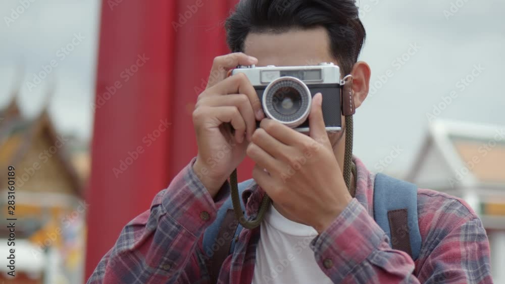 Portrait of handsome young Asian man solo tourists taking a photo the giant swing of Thailand. Asian man blogger happy enjoying leisure lifestyle travel. Portrait of handsome young Asian man solo tourists taking a photo the giant swing of Thailand. Asian man blogger happy enjoying leisure lifestyle travel.
