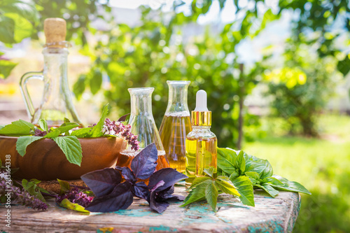 Obraz na plátně Oil for skin care, massage from natural ingredients, herbs, mint in glass jars a