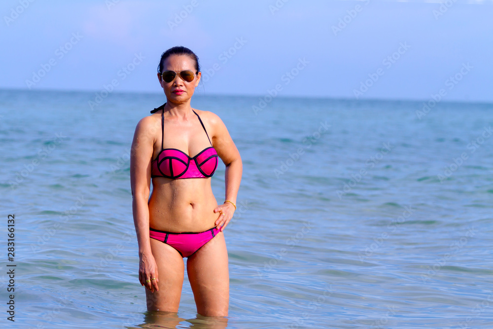 Woman and bikini pink show body beautiful on beach