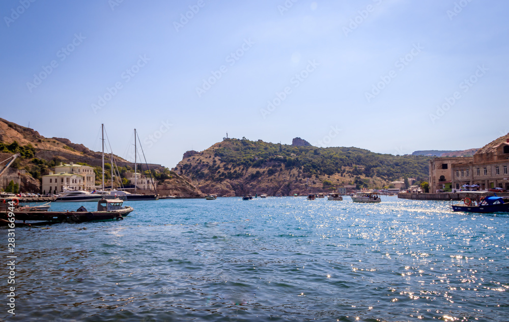 Balaklava bay in summer in sunny weather. Crimea, Russia. A lot of boats and ships. Bay for boats.