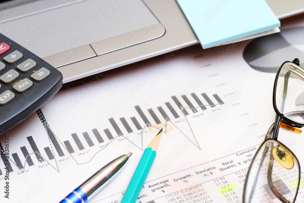 Business concept with a report, money and a calculator Business concept with a report, money and a calculator