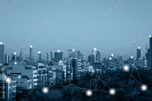Communication network concept 5G smart city on blue background. Modern city with wireless network connection concept. Blue tone city scape and network connection concept.